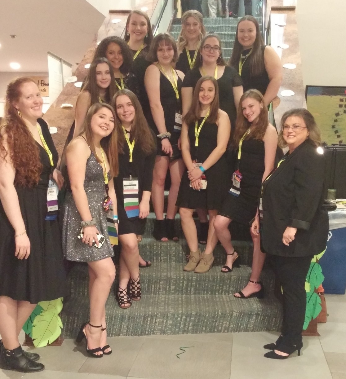 11 high school students and 2 adults dressed up for an award ceremony 